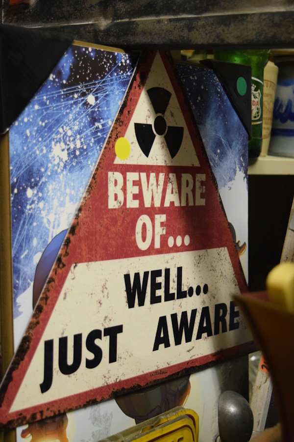 An old red, white and black radiation sign stating Beware of...Well... just aware.