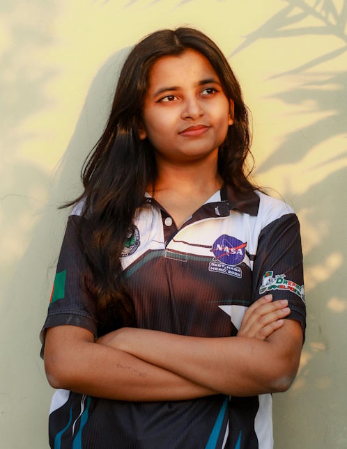 Confident smiling girl with NASA badge on her tshirt.